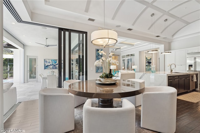 dining space featuring coffered ceiling and sink