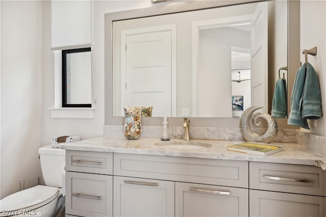 bathroom featuring vanity and toilet