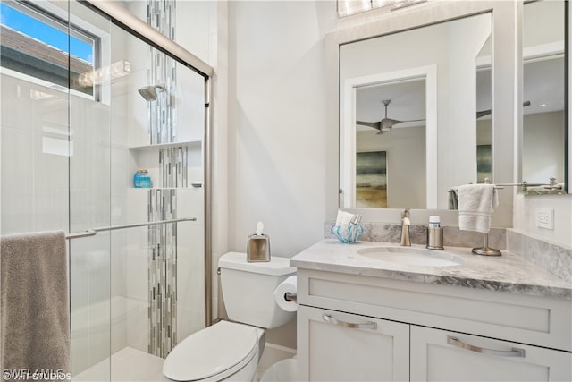 bathroom with vanity, an enclosed shower, and toilet