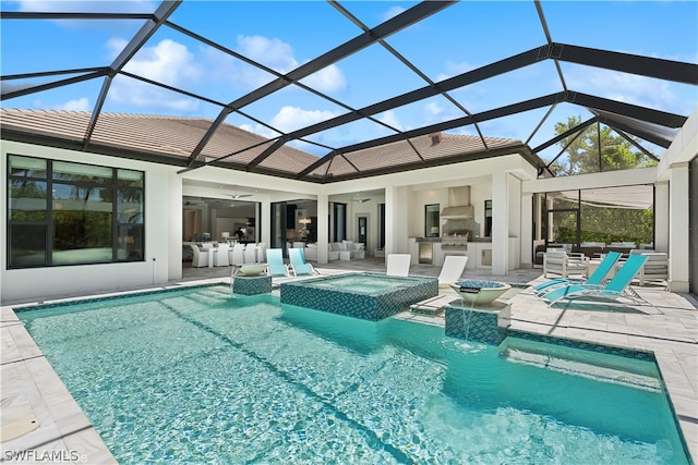 view of swimming pool featuring exterior kitchen, a patio, an in ground hot tub, and glass enclosure