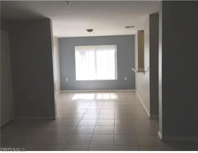 spare room featuring tile floors