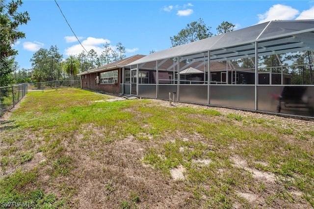 view of yard with glass enclosure