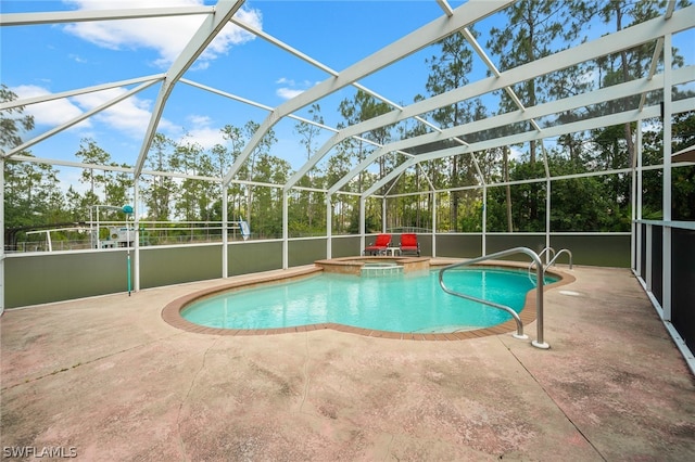 view of swimming pool with glass enclosure and a patio