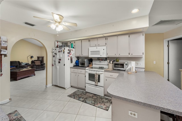 kitchen with white appliances, kitchen peninsula, ceiling fan, and light tile floors