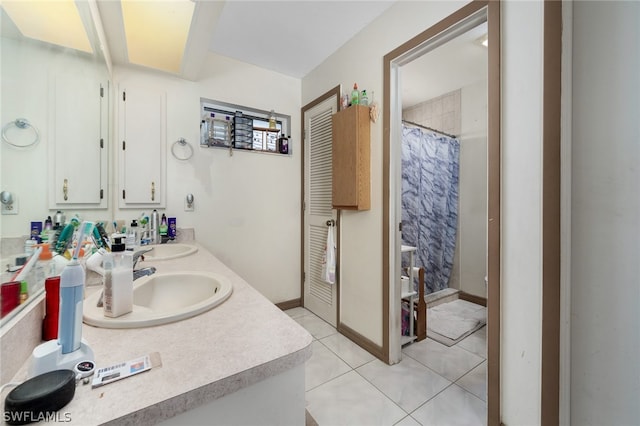 bathroom featuring tile floors and double sink vanity