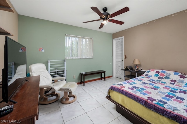 tiled bedroom featuring ceiling fan