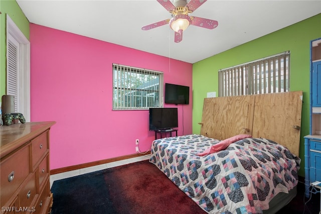 bedroom featuring multiple windows and ceiling fan