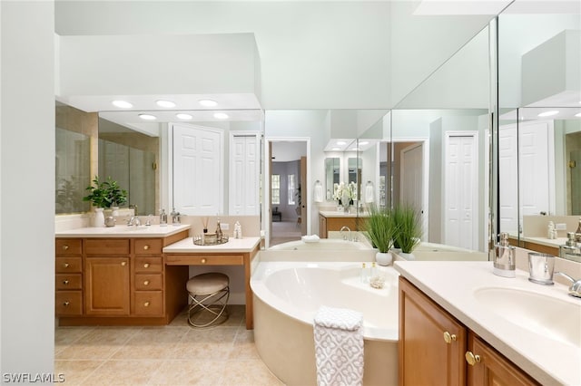 bathroom featuring tile patterned floors, vanity, and a tub