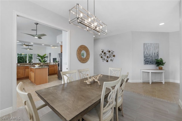 dining room with ceiling fan with notable chandelier