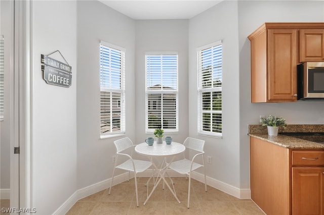 unfurnished dining area with a wealth of natural light and light tile patterned floors