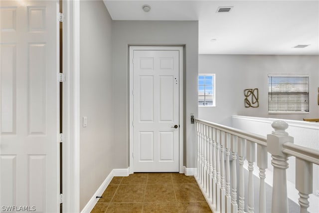 hallway featuring tile patterned flooring