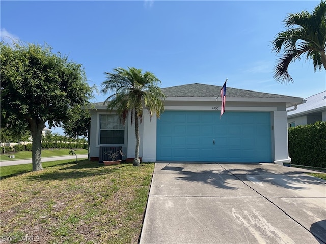 ranch-style home with a garage and a front lawn