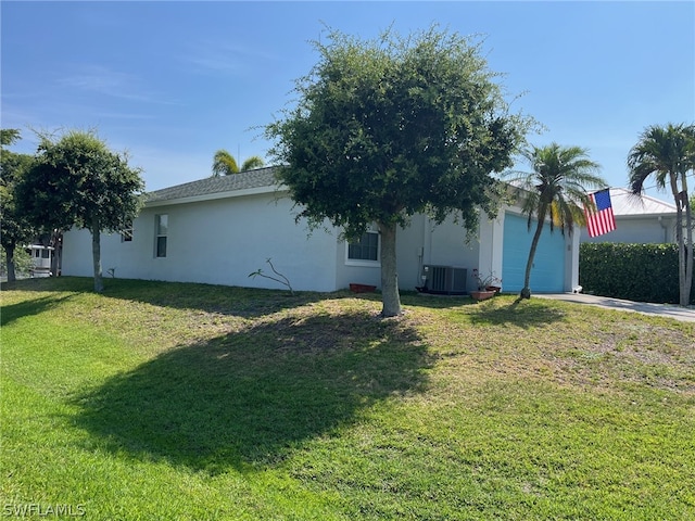 view of side of property with central air condition unit and a lawn