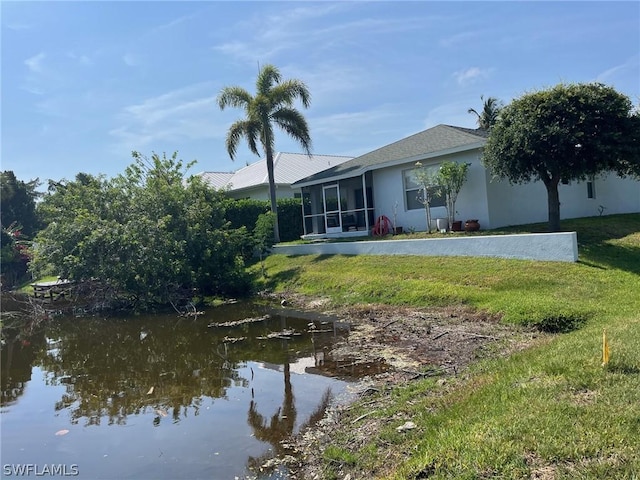 2480 Lake Ave, Naples, FL 34112 - back of property with a yard, stucco siding, and a sunroom