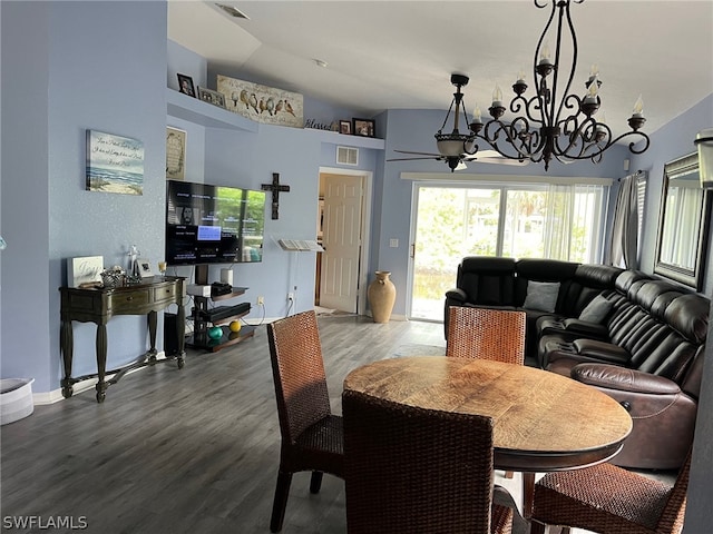 dining room featuring vaulted ceiling, an inviting chandelier, and wood-type flooring