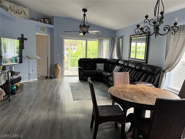 dining area featuring a wealth of natural light, ceiling fan with notable chandelier, lofted ceiling, and wood-type flooring