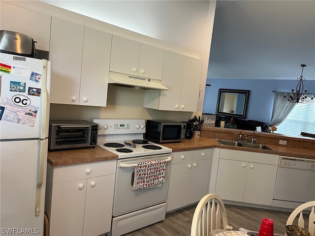 kitchen featuring hardwood / wood-style floors, white appliances, hanging light fixtures, sink, and white cabinetry