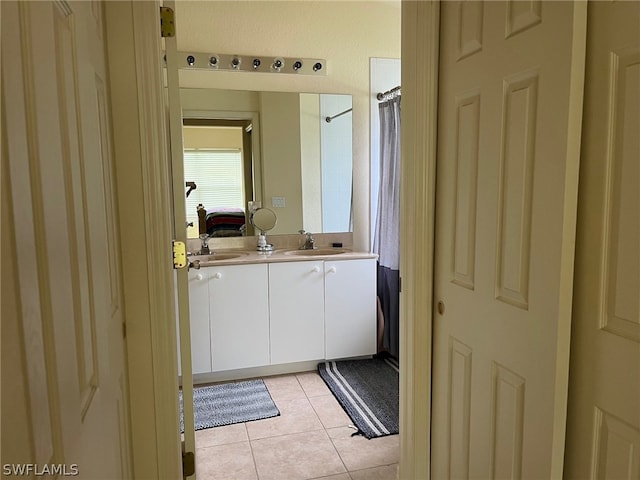 bathroom featuring tile flooring and vanity with extensive cabinet space