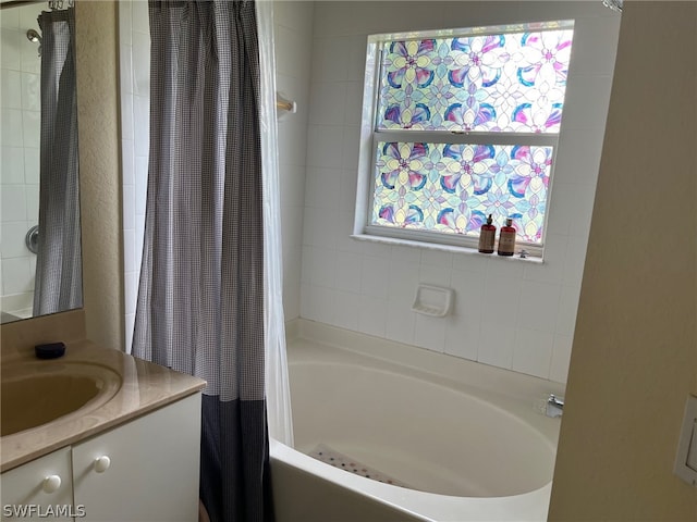 bathroom with plenty of natural light, vanity, and shower / bath combo