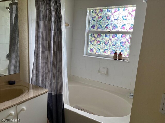 2480 Lake Ave, Naples, FL 34112 - bathroom featuring shower / tub combo with curtain and vanity