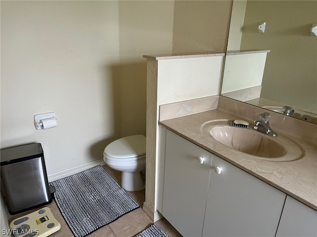 bathroom with tile flooring, vanity, and toilet