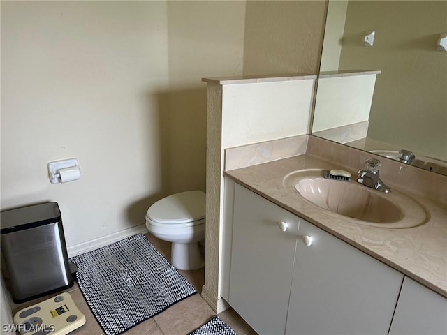 2480 Lake Ave, Naples, FL 34112 - half bathroom with vanity, toilet, tile patterned flooring, and baseboards