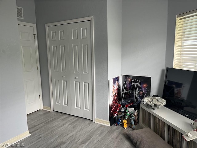 2480 Lake Ave, Naples, FL 34112 - bedroom with baseboards, wood finished floors, and a closet