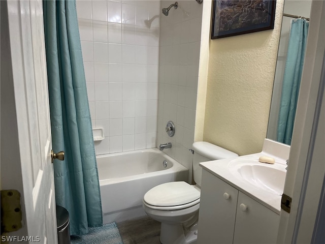 full bathroom featuring wood-type flooring, shower / bath combo with shower curtain, toilet, and large vanity