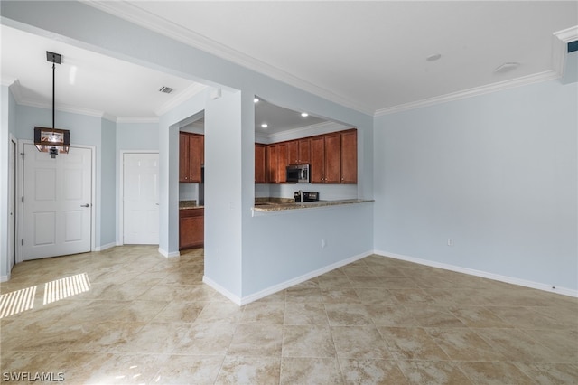 kitchen with light tile patterned floors, kitchen peninsula, crown molding, and hanging light fixtures