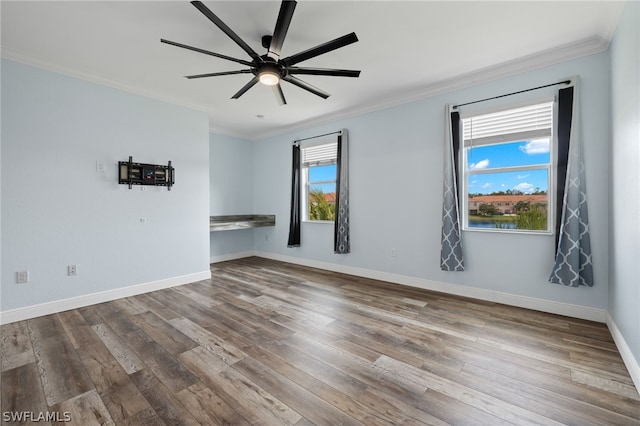 spare room with ceiling fan, wood-type flooring, and crown molding