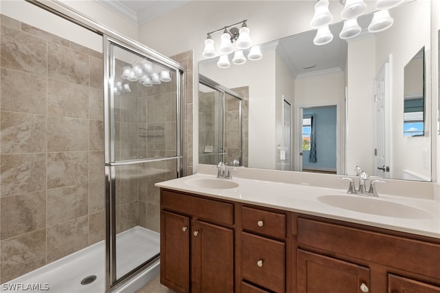 bathroom with vanity, a shower with door, crown molding, and a notable chandelier