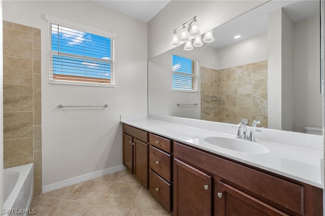 bathroom with toilet, vanity, tile patterned floors, and a notable chandelier