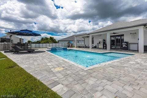 view of swimming pool with a patio and ceiling fan