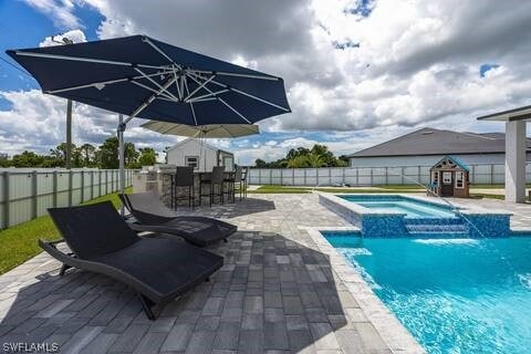 view of swimming pool featuring an in ground hot tub, a bar, a patio, and pool water feature