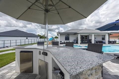 view of patio / terrace featuring a fenced in pool