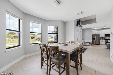 dining space with light tile patterned floors