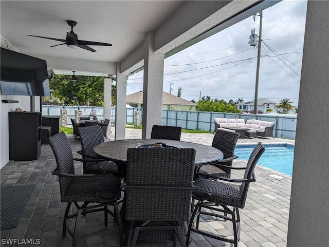 view of patio / terrace with ceiling fan, a fenced in pool, and an outdoor hangout area