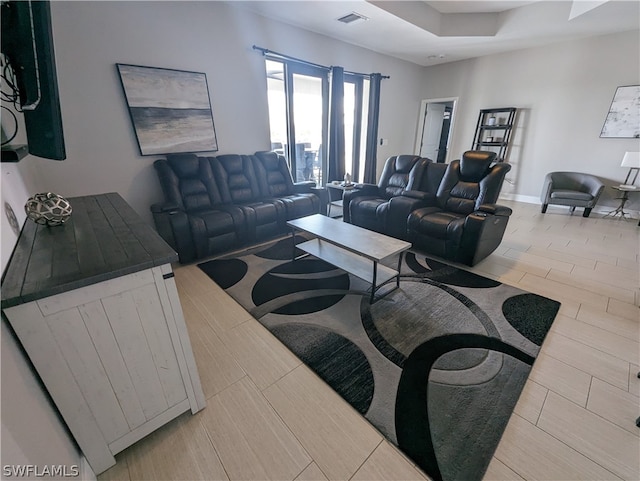 living room featuring a tray ceiling