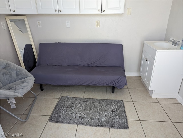 living area with light tile patterned floors and sink