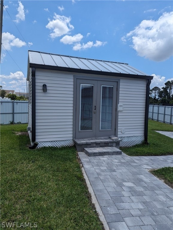 exterior space featuring french doors and a yard