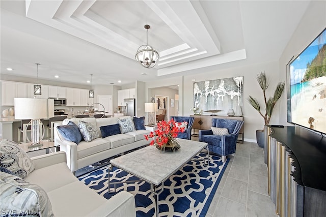 tiled living room featuring a tray ceiling and an inviting chandelier