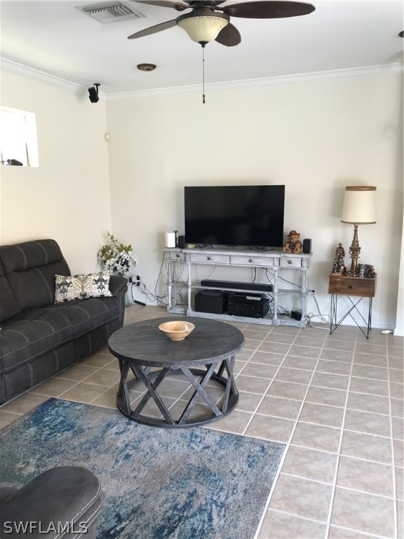 living room featuring tile floors, ceiling fan, and crown molding