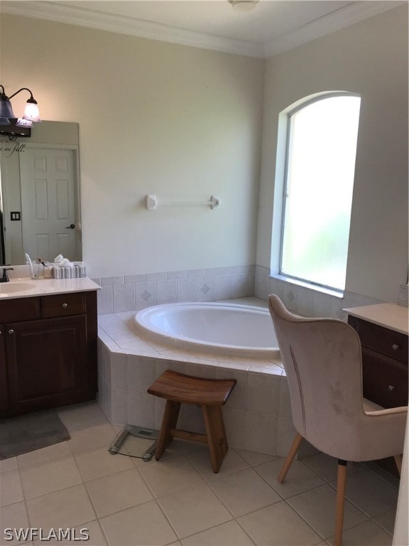 bathroom with a relaxing tiled bath, tile flooring, plenty of natural light, and vanity