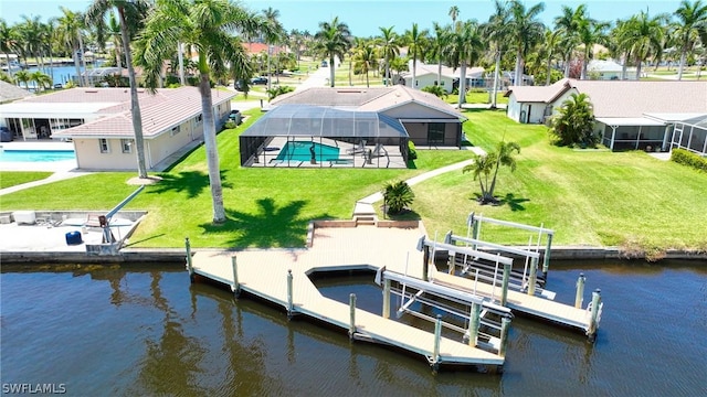 dock area featuring a water view, a lanai, and a lawn