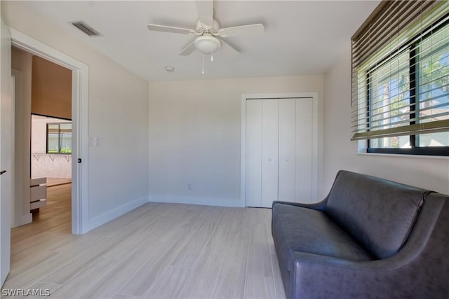 sitting room featuring light hardwood / wood-style flooring and ceiling fan