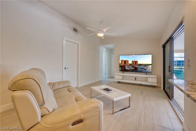 living room with ceiling fan and hardwood / wood-style floors