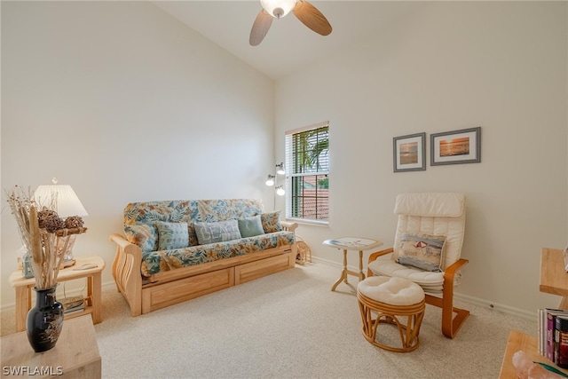 carpeted living room with high vaulted ceiling and ceiling fan