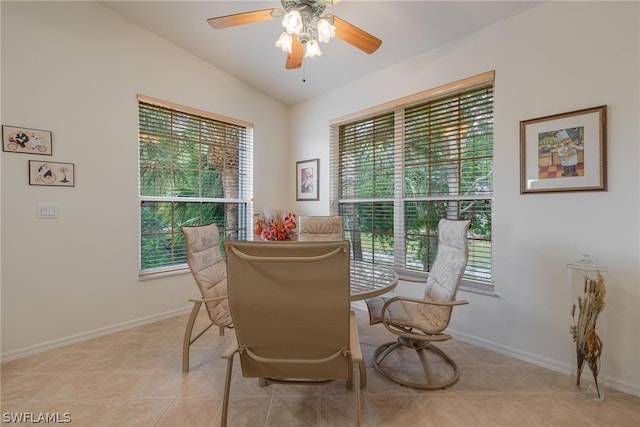 tiled dining area with vaulted ceiling and ceiling fan