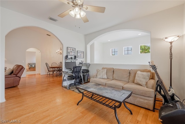 living room with ceiling fan and light wood-type flooring