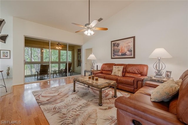 living room featuring high vaulted ceiling, ceiling fan, and wood-type flooring